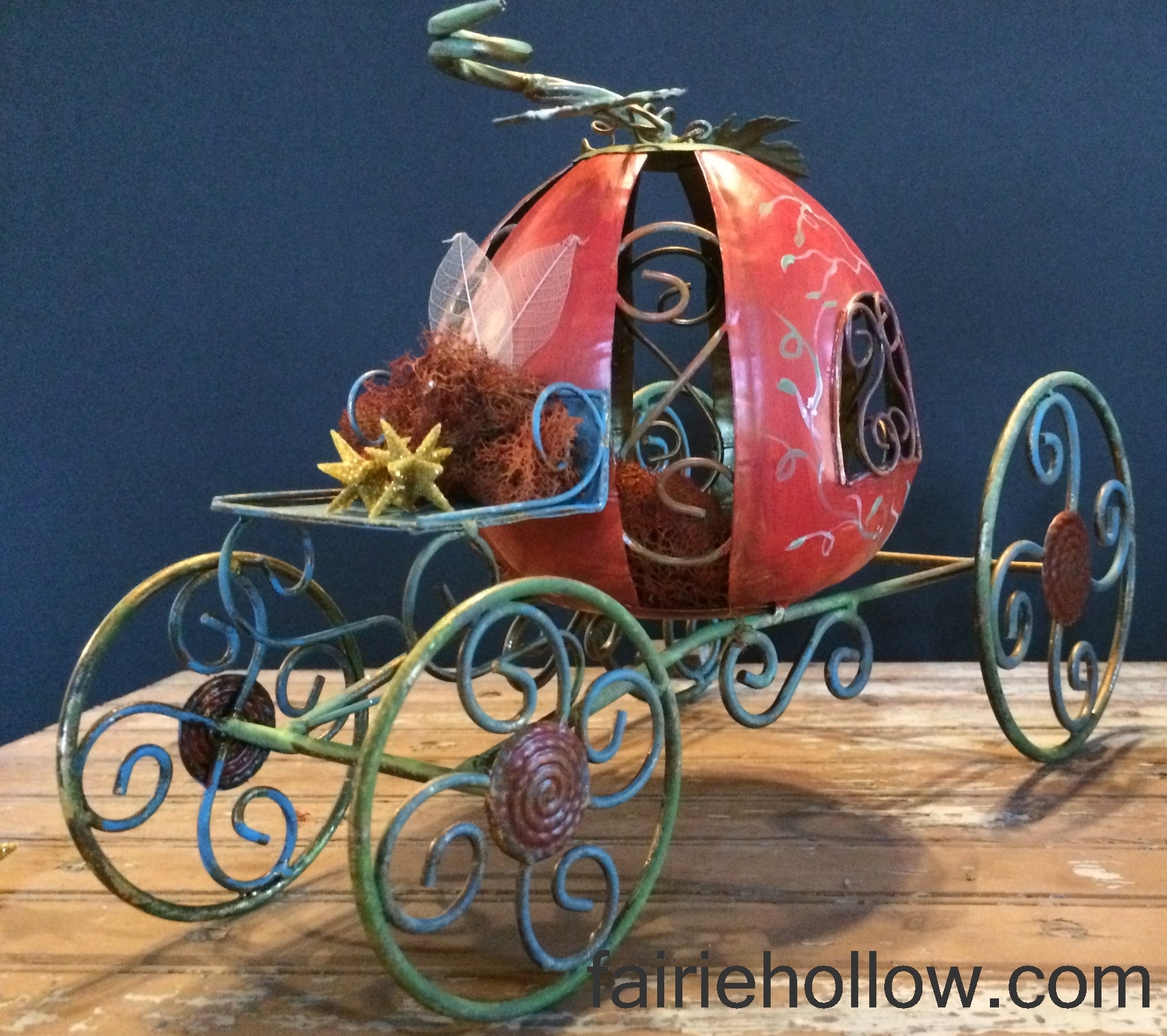 enchanted metal fairy pumpkin-carriage painted orange and green with vines