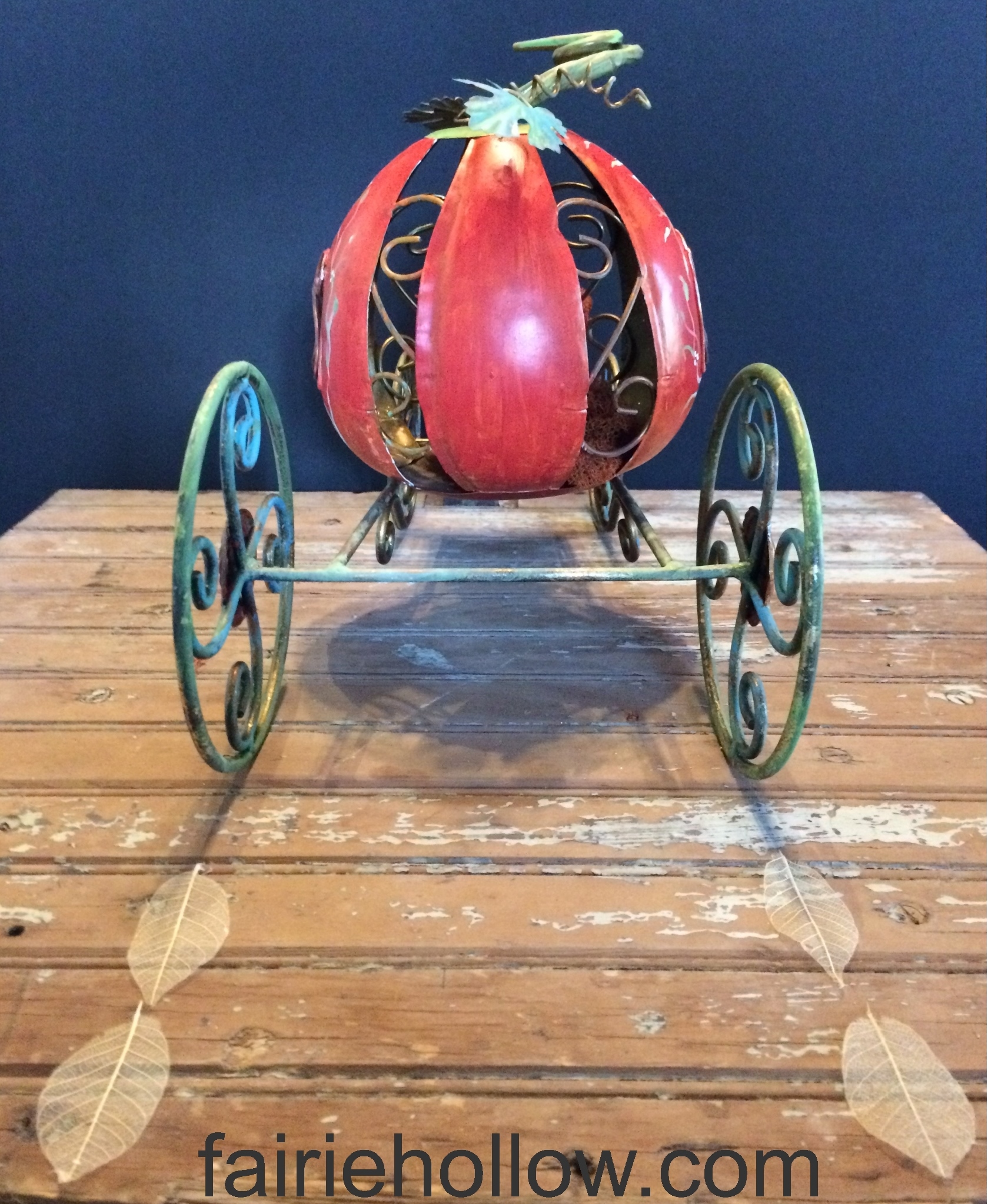 DIY fairy pumpkin carriage painted orange with green wheels. fairiehollow.com
